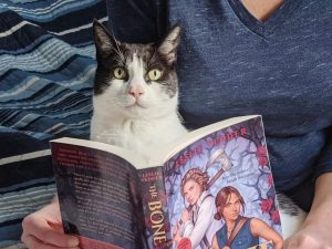 Leslie Vedder and cat reading the Bone Spindle