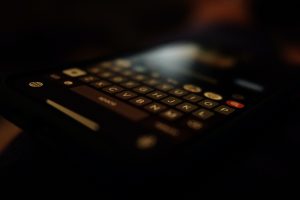 Image of a qwerty keyboard on a phone represents the text to suicide in The Girl from Plainville series.
