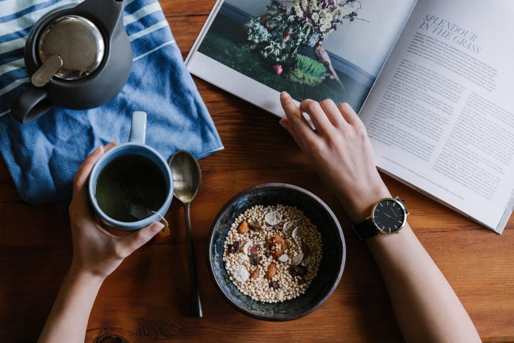 in an article about developing healthy habits, a person with coffee and a bowl of cereal