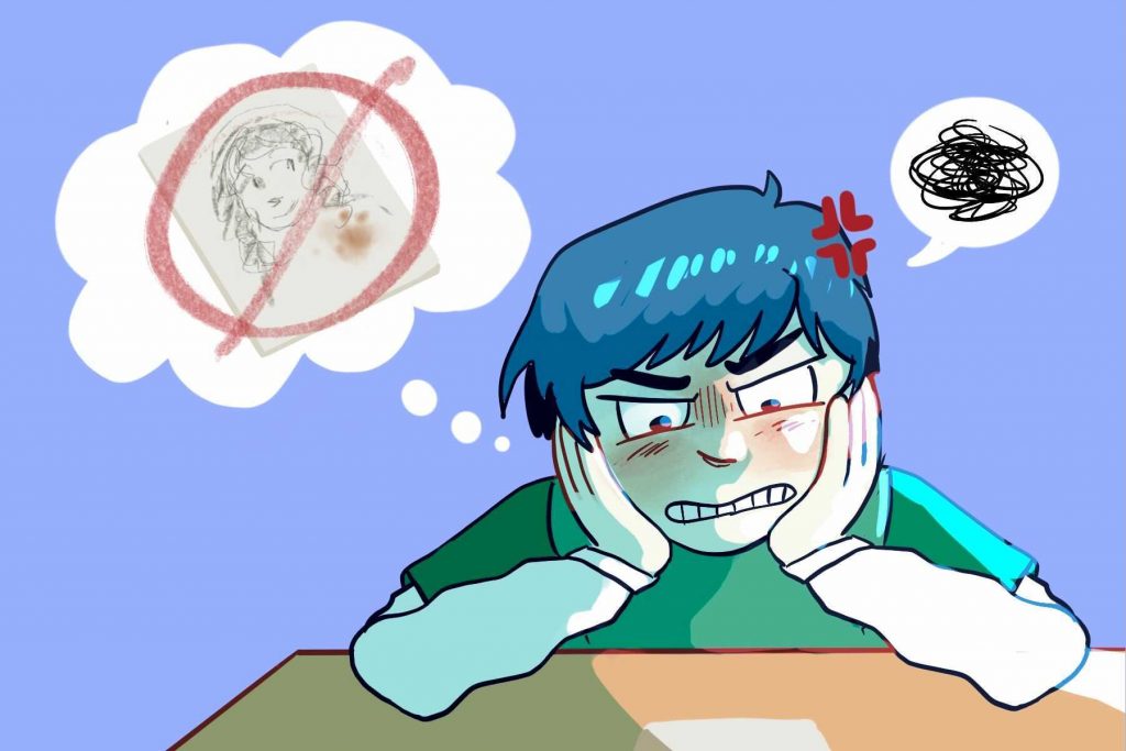 in an article about perfectionists, a frustrated student looking at a desk