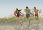 A screenshot from The Summer I Turned Pretty shows three young people running down a sand dune.