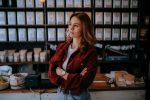 In an article about entrepreneurs and college, a person standing in front of some merchandise