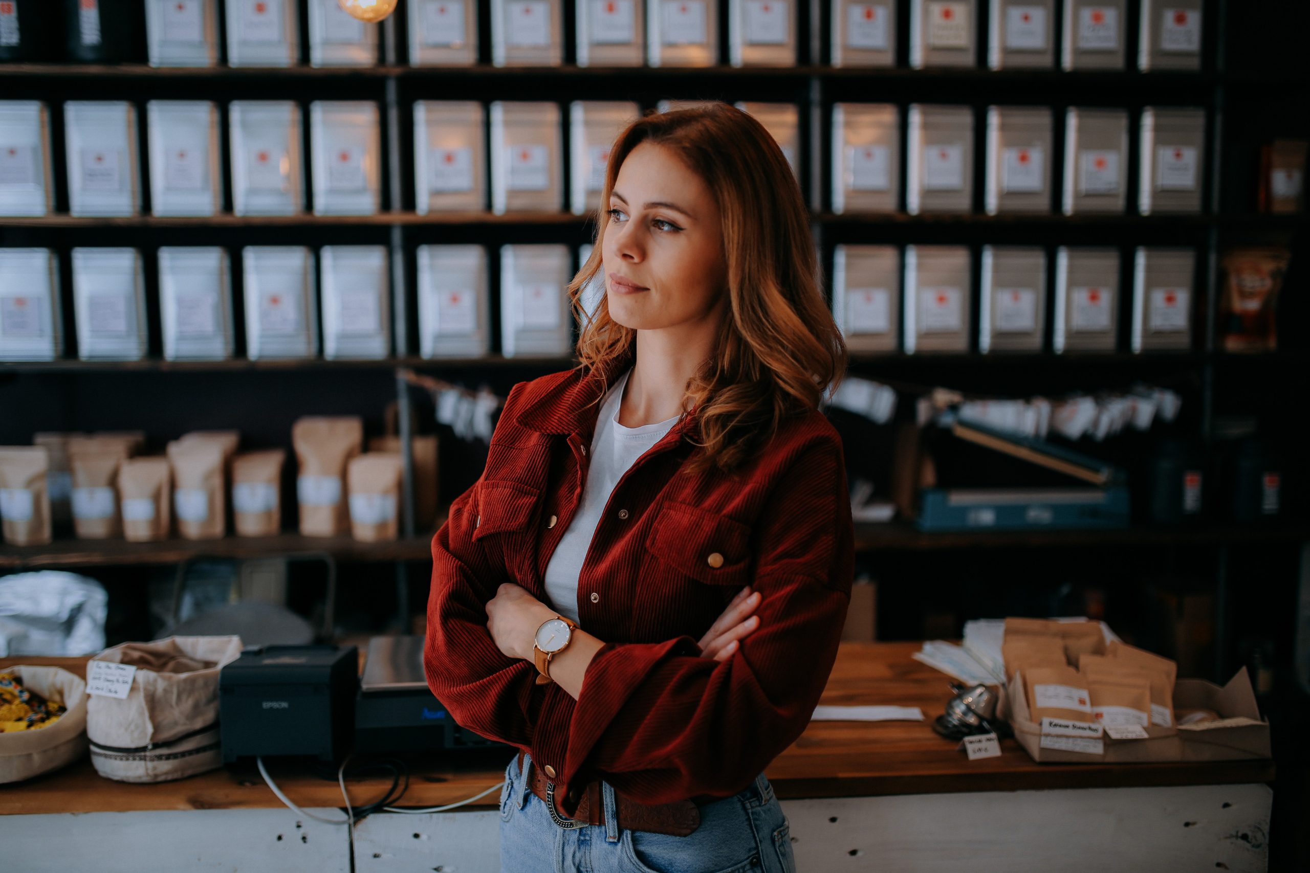 In an article about entrepreneurs and college, a person standing in front of some merchandise
