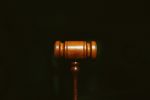 in an article about the depp v. heard case, a photo of a gavel against a black background