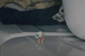 Marcel the Shell stares off into the distance on top of a washing machine
