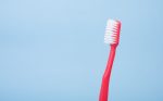 in an article about oral health, a red toothbrush