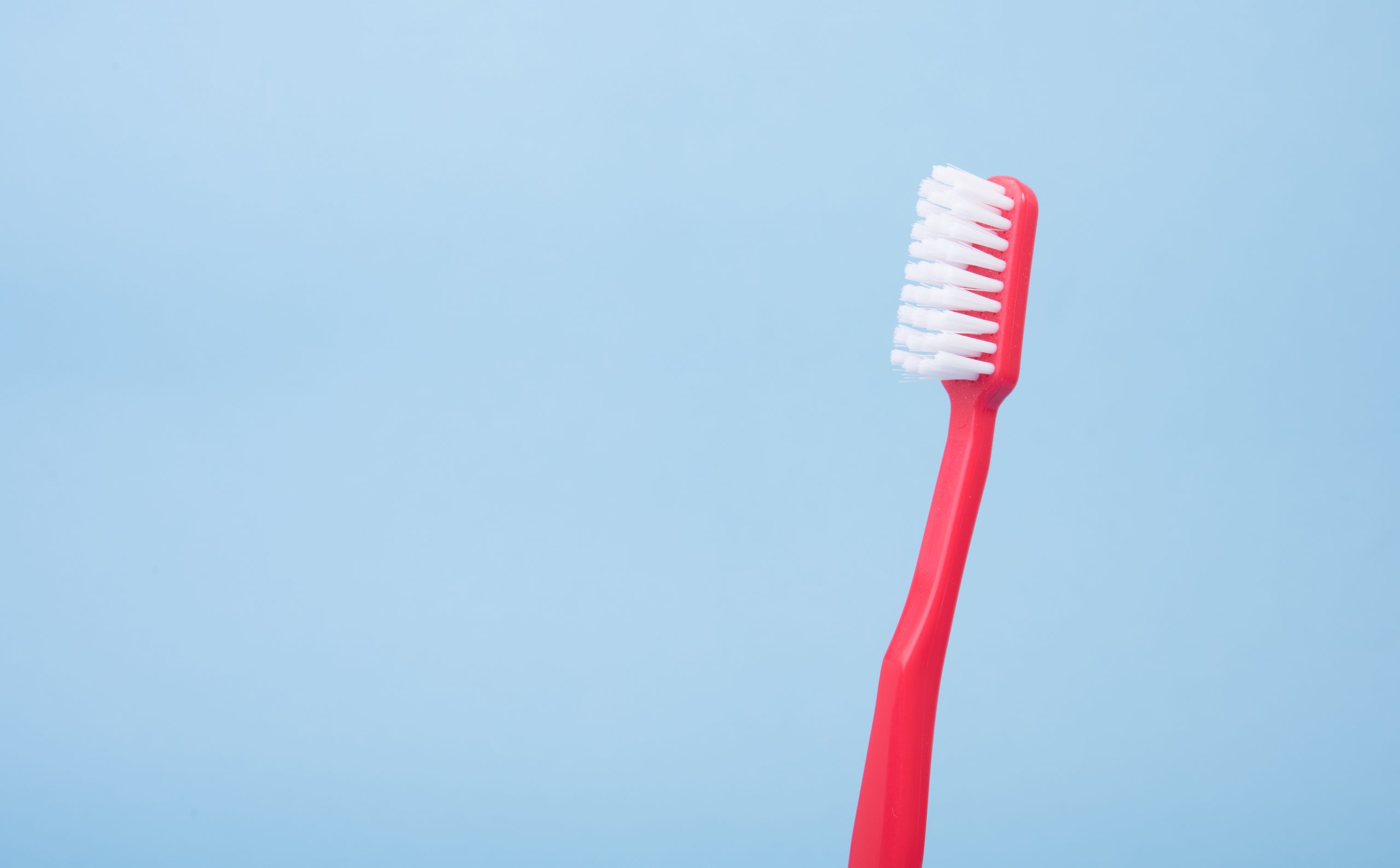 in an article about oral health, a red toothbrush