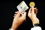 someone with $50 in currency exchanging it for a Bitcoin token