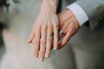 a married couple showing off their wedding rings