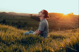 in an article about ikigai, a person sitting in a meadow