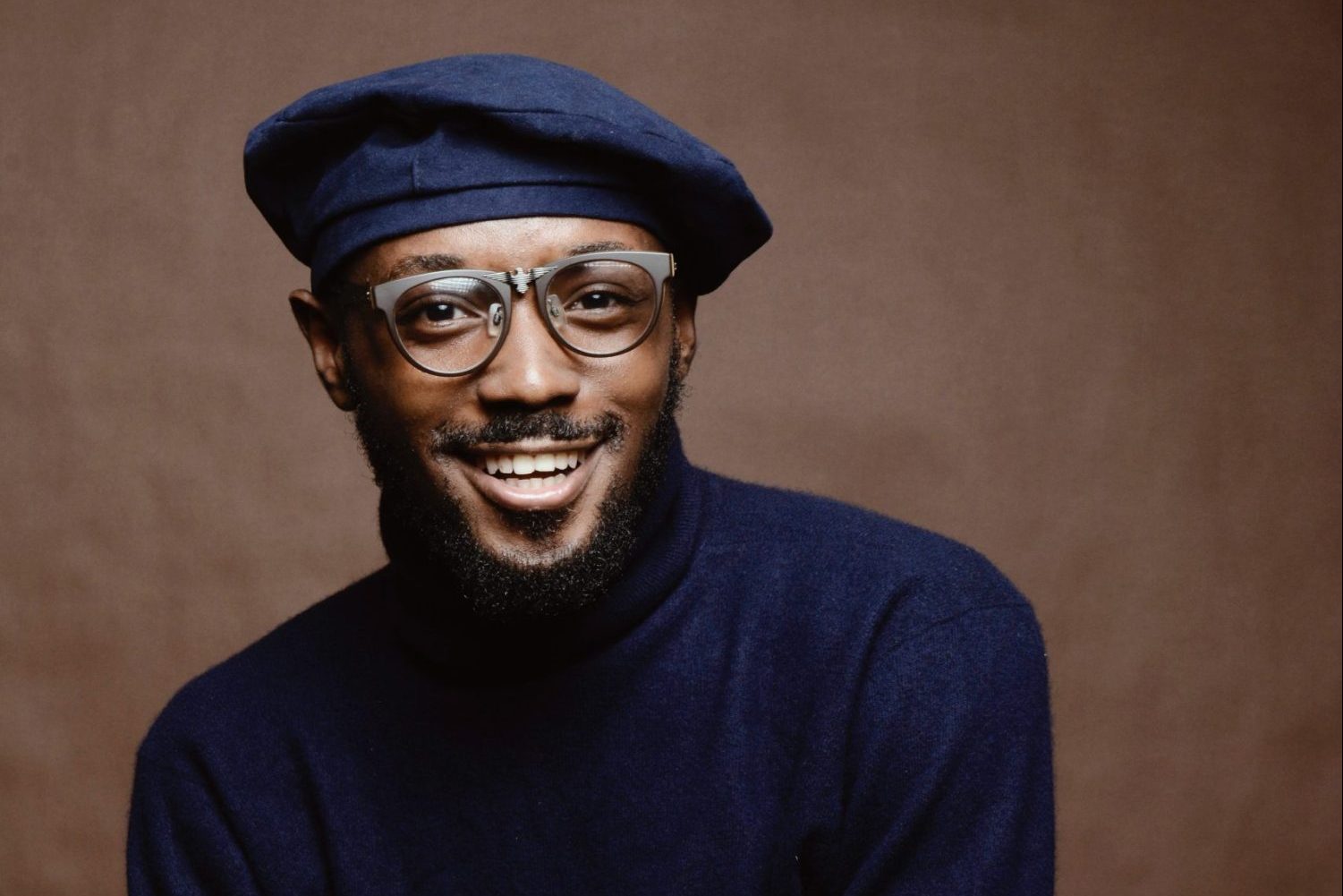 in an article about African students, a smiling man with a camera