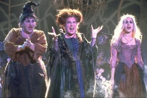for an article about Halloween movies, three witches from the film Hocus Pocus laughing gleefully