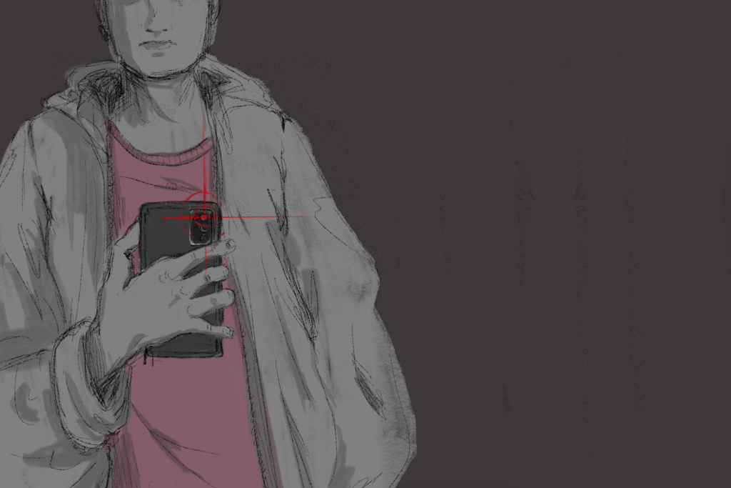 An article about online posting has an image of a person pointing their phone camera at the viewer