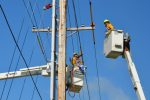 In an article about bucket bunnies, an image of two linemen maintaining powerlines