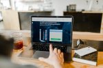 in article about states and casino revenue, a person looking at a laptop