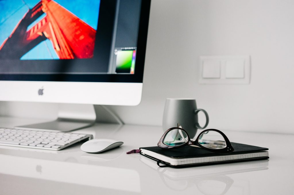 Work from home imagery of a desktop computer and notebook