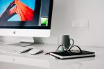 Work from home imagery of a desktop computer and notebook