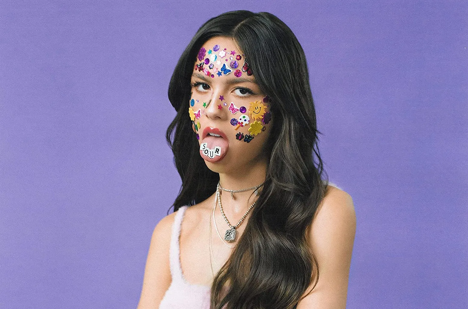 Olivia Rodrigo album cover for "Sour," which began her feud with Carpenter. She stands with her tongue out and she arms crossed.