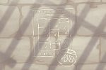 In an article about prison labor, the stone wall of a prison cell is etched with a completed ballot and the carved out emblem of an 'I Voted' sticker.