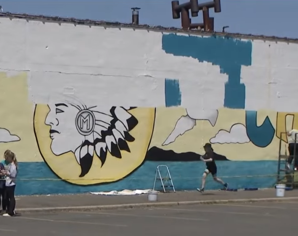 In this article about Massapequa, a mural of the town's mascot, a Native American chief is reaching completion.