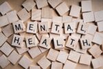 In an article about mental health. Mental health written out with scrabble pieces.