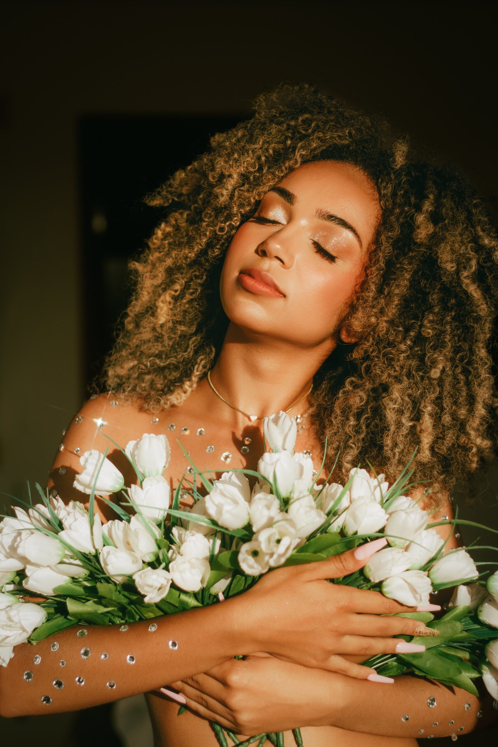 In a story about plastic surgery woman holding flowers over her chest.