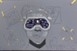 For an article about surveillance culture, a person wears an eye glass piece with the words "no," "buy," "obey," "overturned," "overruled" on it. A city scape is behind them and different fliers are posted too.
