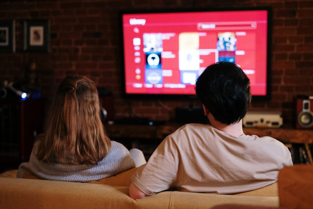 Man and woman on couch watching TV