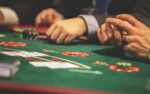 Hands on a Black Jack Table.