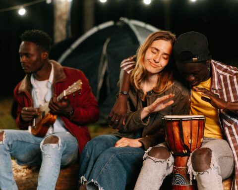 Men and women playing Ukelele and Bongo