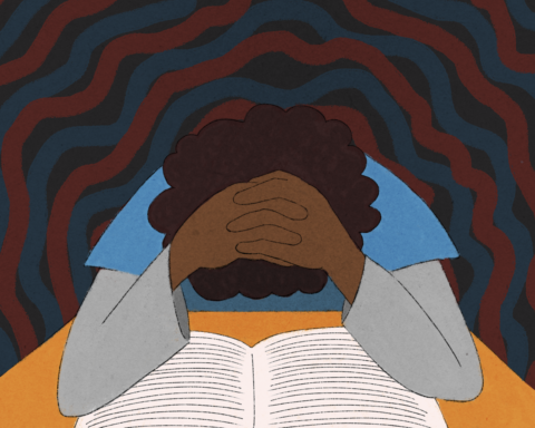 POC with head in hands over a book.