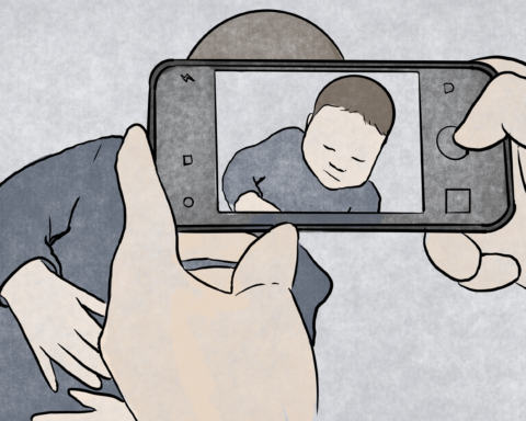 Someone taking a picture of their young child.