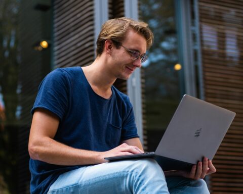 man sitting in front of a laptop