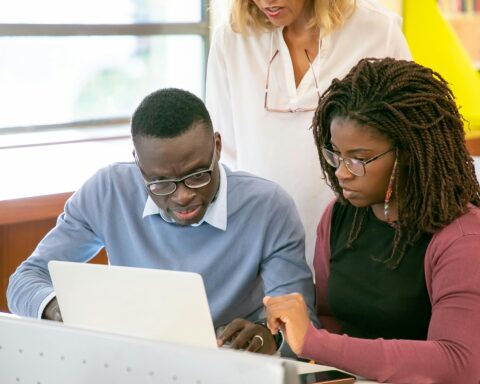 Two students in front of a laptop